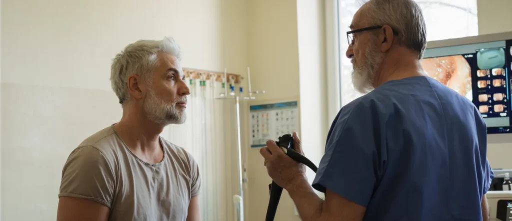 A provider meets with a patient for a colon cancer screening.
